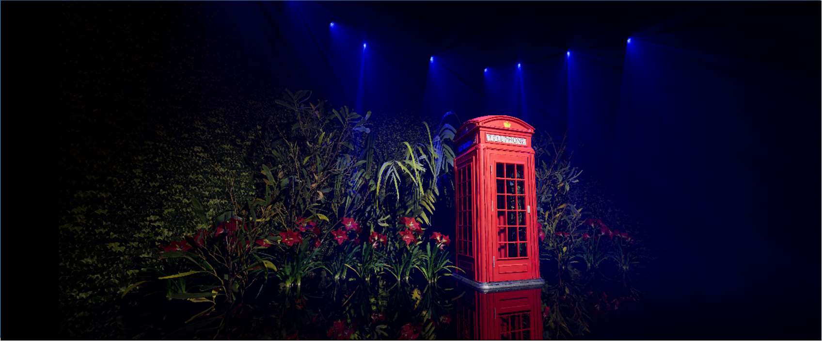Unreal Engine render of a lit red phone booth in a planted display